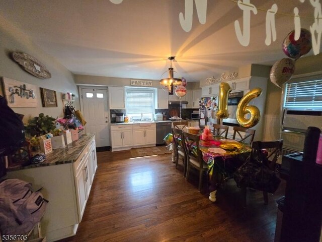 50 Newark Pl, Belleville Twp, NJ 07109 - dining area with dark wood-style flooring and a chandelier