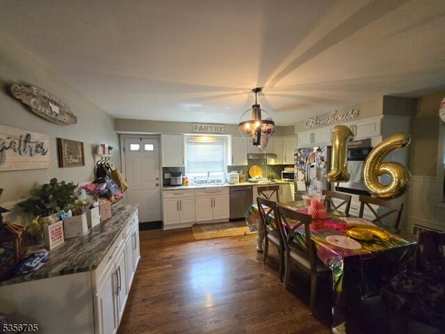 50 Newark Pl, Belleville Twp, NJ 07109 - kitchen featuring stainless steel appliances, white cabinets, a sink, dark wood-style floors, and tasteful backsplash