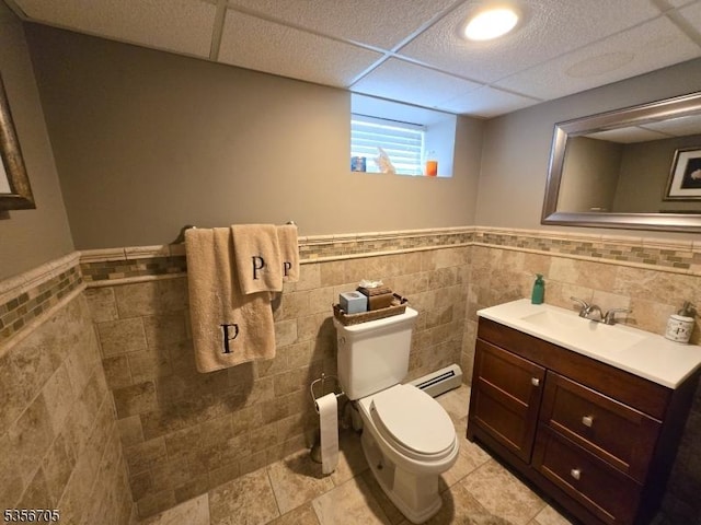 50 Newark Pl, Belleville Twp, NJ 07109 - half bath with baseboard heating, wainscoting, tile walls, toilet, and vanity
