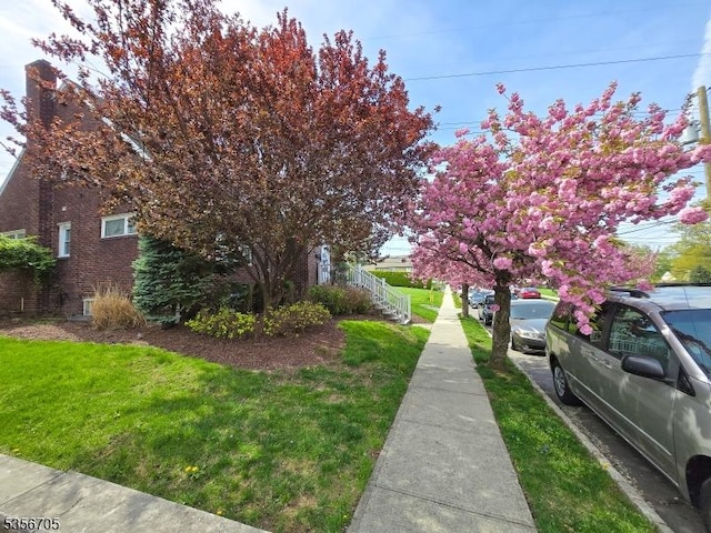 50 Newark Pl, Belleville Twp, NJ 07109 - view of side of home featuring a yard and brick siding