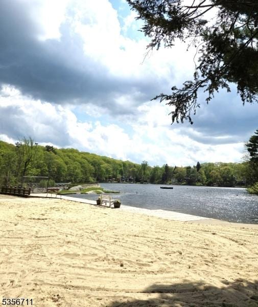 surrounding community featuring a water view and a forest view