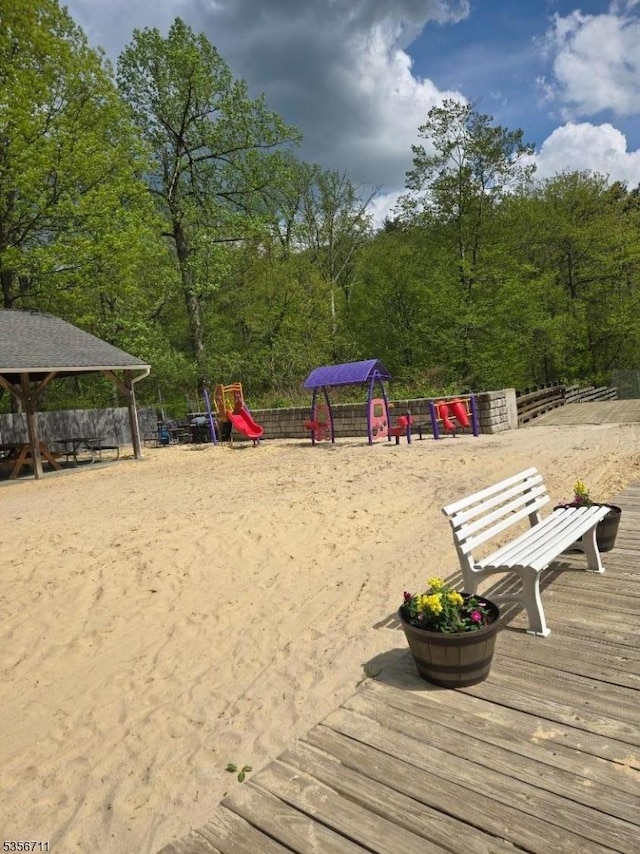 view of home's community with fence and a wooded view