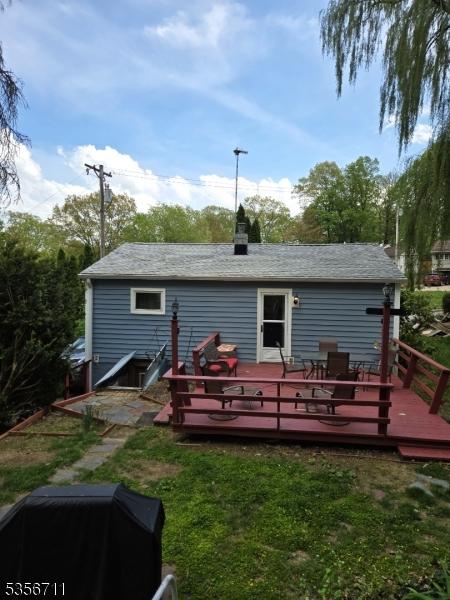 rear view of property with a wooden deck