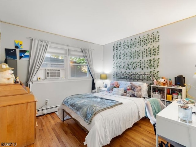 bedroom featuring a baseboard radiator, wood finished floors, and cooling unit