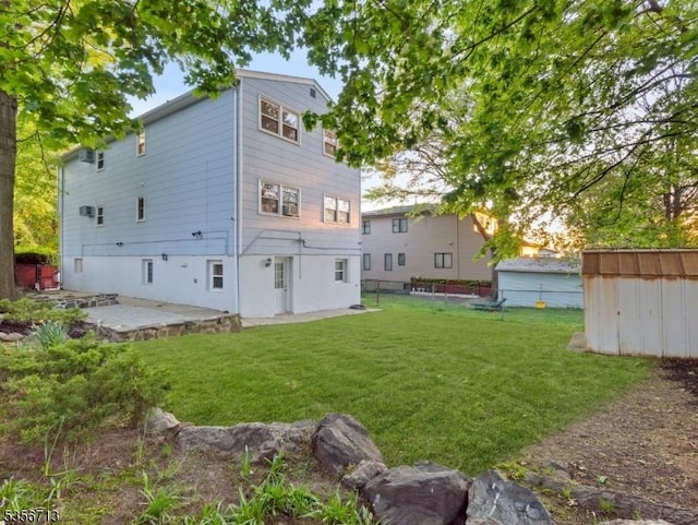 back of property with a patio, a storage shed, and an outdoor structure