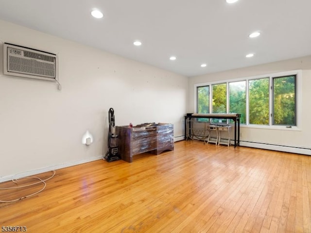 misc room featuring hardwood / wood-style floors, recessed lighting, an AC wall unit, and baseboard heating