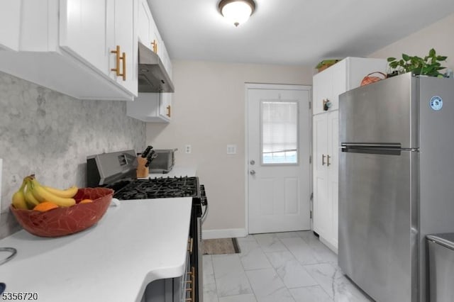kitchen with stainless steel appliances, under cabinet range hood, light marble finish flooring, white cabinets, and light countertops