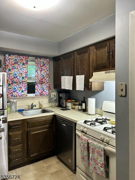 703 Nottingham Way, Raritan Twp, NJ 08822 - kitchen featuring gas range gas stove, dishwasher, under cabinet range hood, a sink, and freestanding refrigerator