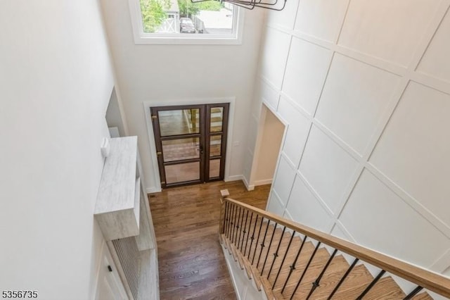 entryway with wood finished floors, a chandelier, and stairway