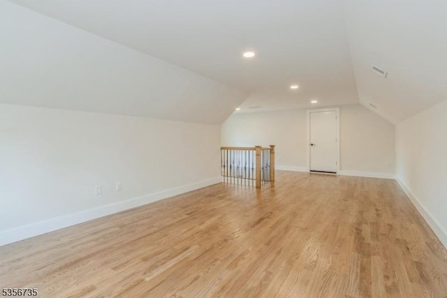 bonus room featuring lofted ceiling, light wood-style flooring, baseboards, and recessed lighting