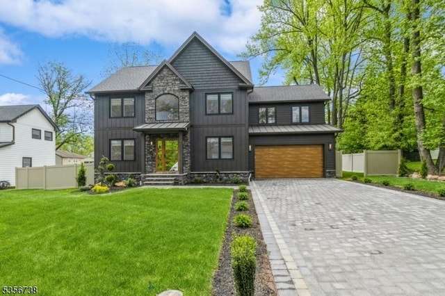 view of front of property with a standing seam roof, a garage, decorative driveway, stone siding, and metal roof