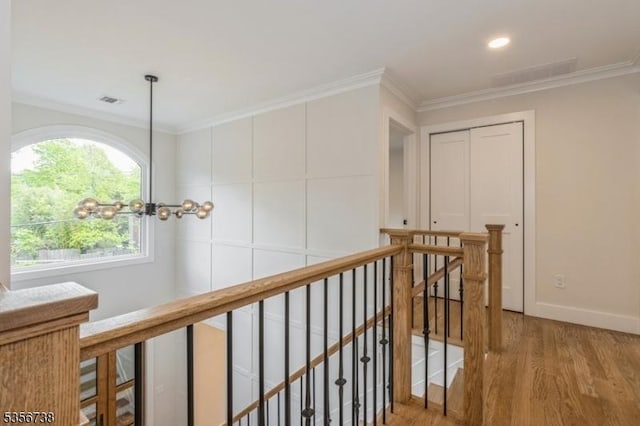 hallway featuring an upstairs landing, wood finished floors, crown molding, baseboards, and recessed lighting