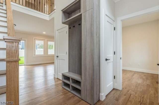 mudroom with wood finished floors and baseboards