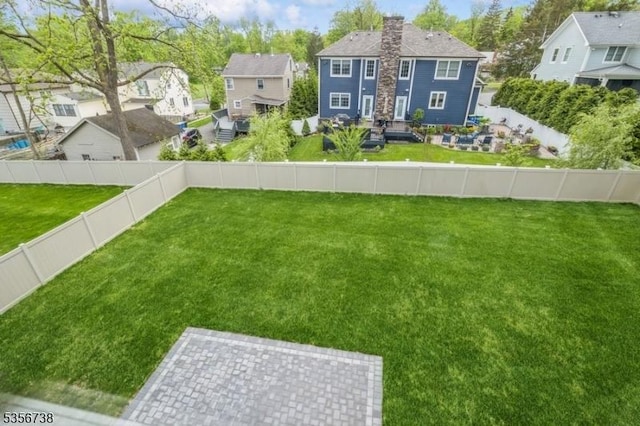 view of yard with a residential view and a patio
