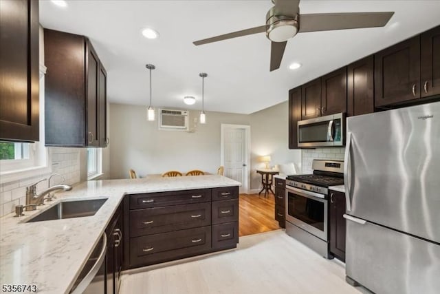 6 Cumberland Rd, Hillsborough Twp, NJ 08844 - kitchen featuring stainless steel appliances, a sink, an AC wall unit, tasteful backsplash, and light wood-style floors