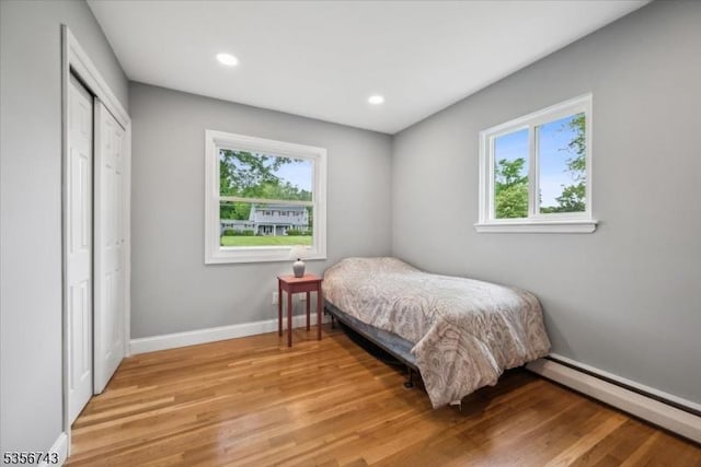 6 Cumberland Rd, Hillsborough Twp, NJ 08844 - bedroom featuring a baseboard heating unit, light wood-style floors, baseboards, a closet, and recessed lighting