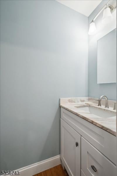 6 Cumberland Rd, Hillsborough Twp, NJ 08844 - bathroom with vanity, wood finished floors, and baseboards