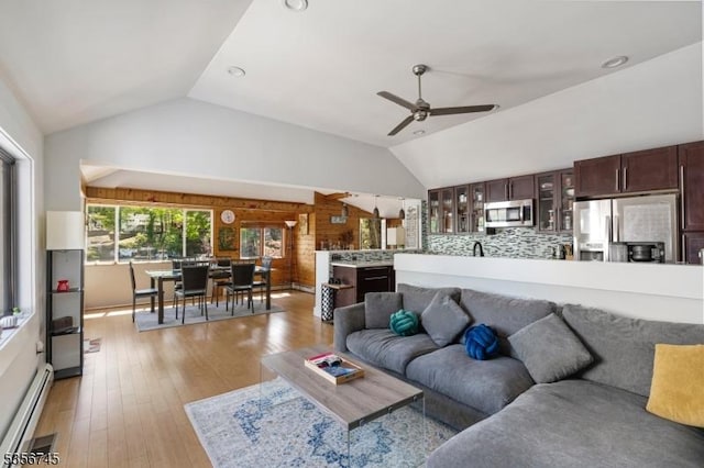 229A Squaw Trl, Hopatcong Boro, NJ 07821 - living area with a baseboard heating unit, vaulted ceiling, ceiling fan, and light wood finished floors