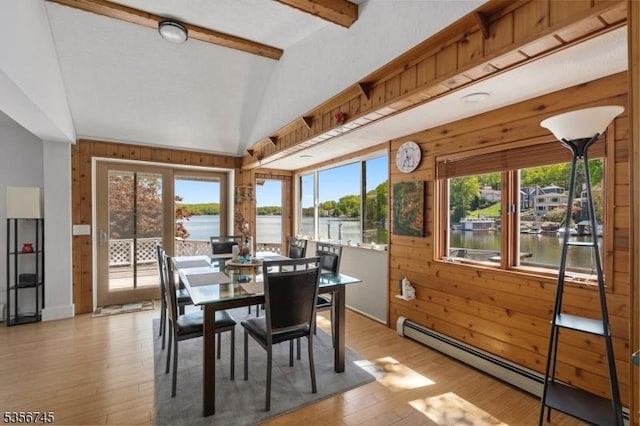 229A Squaw Trl, Hopatcong Boro, NJ 07821 - dining area featuring baseboard heating, wood walls, plenty of natural light, light wood-style flooring, and a water view