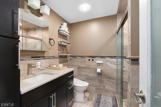 229A Squaw Trl, Hopatcong Boro, NJ 07821 - bathroom featuring toilet, tile walls, a stall shower, vanity, and wainscoting