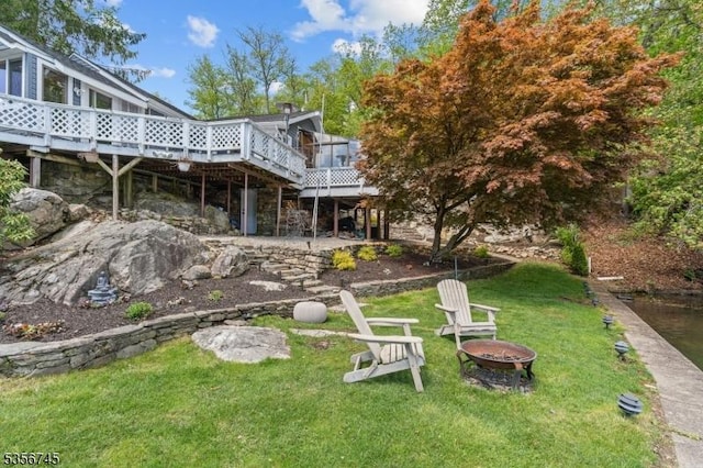 229A Squaw Trl, Hopatcong Boro, NJ 07821 - view of green lawn featuring an outdoor fire pit and a deck