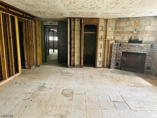 unfurnished living room featuring a brick fireplace