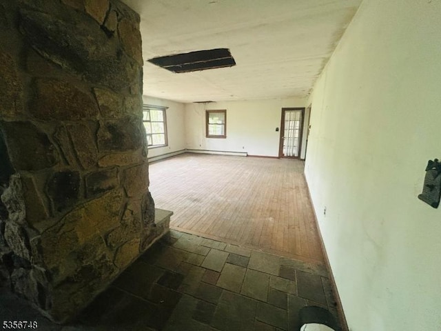 hallway featuring baseboard heating and wood finished floors