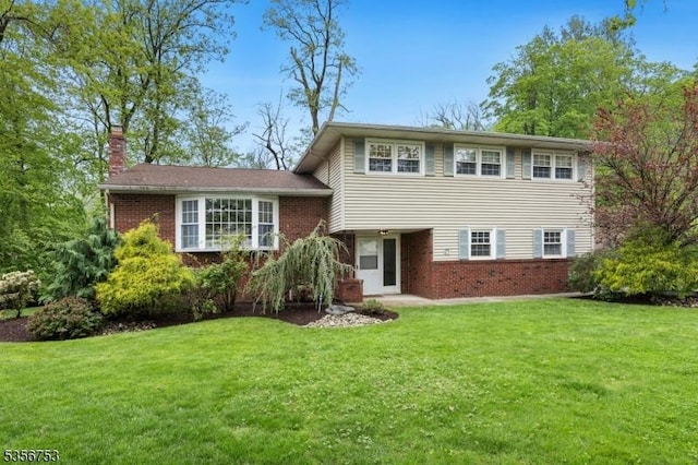 9 Copperfield Rd, Scotch Plains Twp, NJ 07076 - split level home featuring brick siding, a front lawn, and a chimney