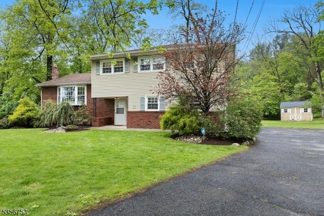 9 Copperfield Rd, Scotch Plains Twp, NJ 07076 - tri-level home featuring brick siding, a shed, a chimney, and an outdoor structure