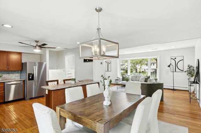 9 Copperfield Rd, Scotch Plains Twp, NJ 07076 - dining space with light wood-style floors, a chandelier, recessed lighting, a ceiling fan, and baseboard heating
