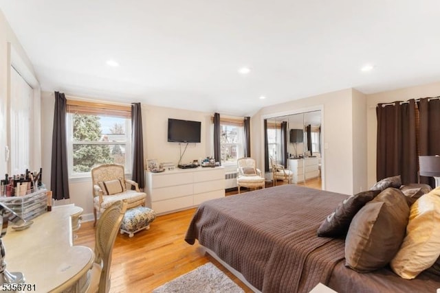 bedroom with light wood-style flooring, recessed lighting, and radiator heating unit