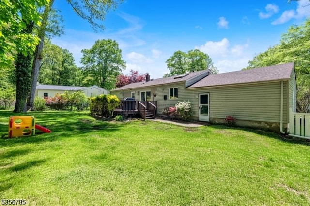 back of house with a wooden deck