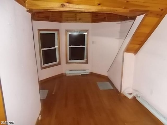 additional living space with a baseboard radiator and wood finished floors