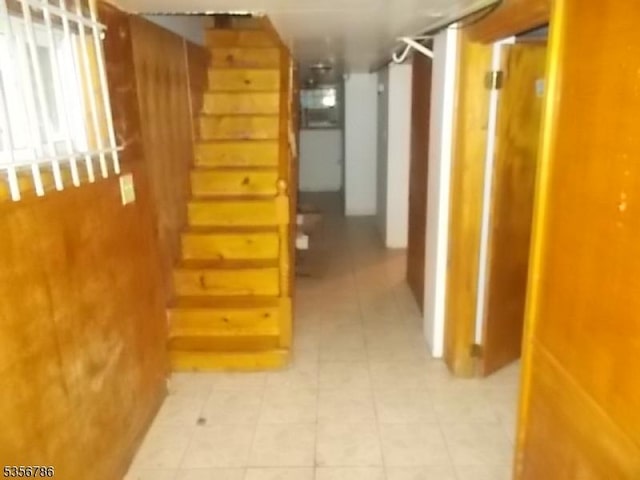 hall with stairs and light tile patterned floors