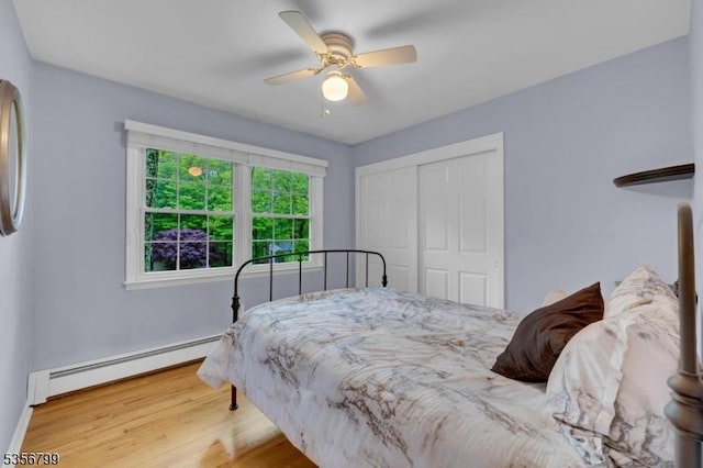 38 Nestlingwood Dr, Washington Twp, NJ 07853 - bedroom with a baseboard heating unit, a closet, wood finished floors, a ceiling fan, and baseboards