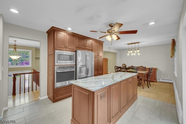 38 Nestlingwood Dr, Washington Twp, NJ 07853 - kitchen featuring appliances with stainless steel finishes, a baseboard heating unit, light stone counters, ceiling fan, and decorative light fixtures