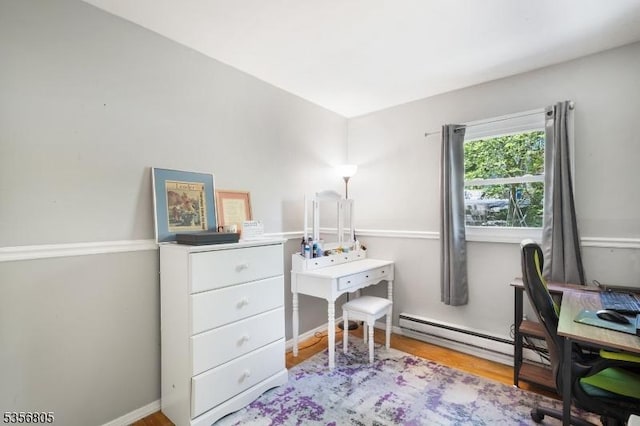 office featuring wood finished floors and a baseboard heating unit