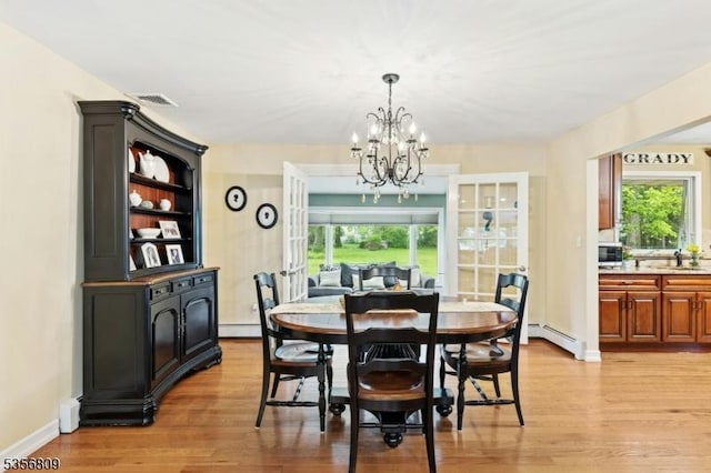 96 Belmont Ave, Cranford Twp, NJ 07016 - dining room with a chandelier, light wood-style flooring, a baseboard heating unit, and healthy amount of natural light