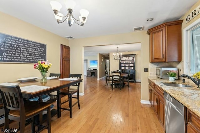96 Belmont Ave, Cranford Twp, NJ 07016 - dining area featuring a chandelier, light wood-style floors, and baseboards