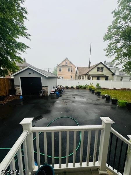 view of yard with fence and an outdoor structure