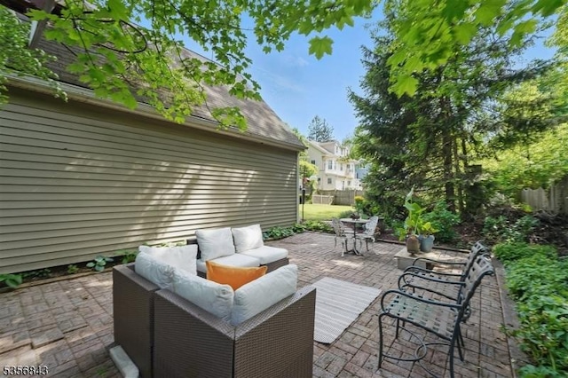 view of patio / terrace featuring an outdoor living space and fence