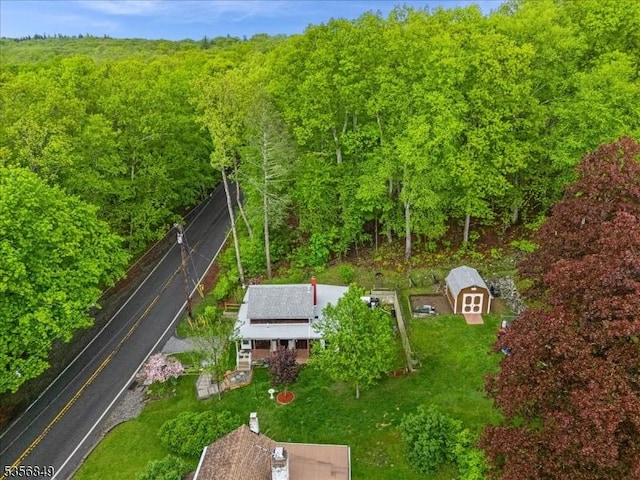 view of subject property with a forest