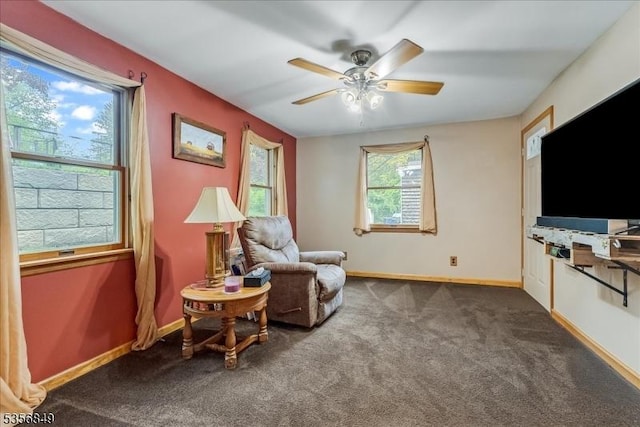living area featuring carpet, ceiling fan, and baseboards