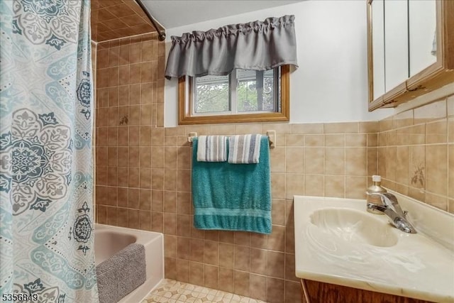 full bath with vanity, tile walls, and shower / tub combo with curtain