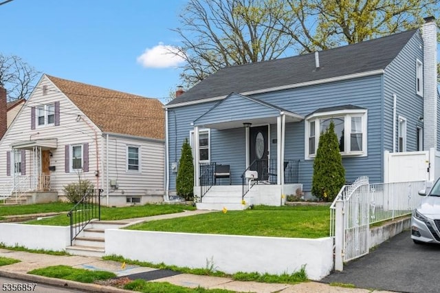 view of front of house featuring a porch, a front lawn, and a chimney