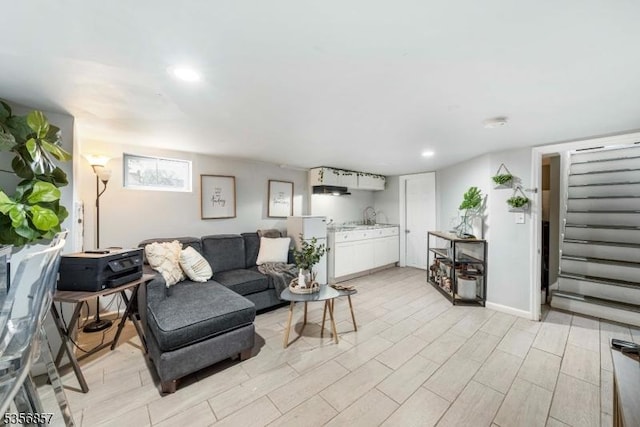 living area featuring stairway, recessed lighting, and light wood-style floors