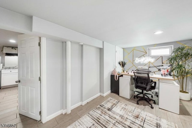 office space with light wood-type flooring and baseboards