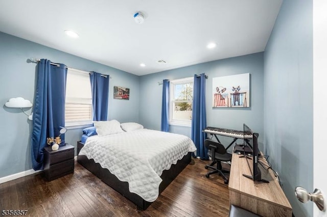 bedroom with dark wood-type flooring, baseboards, and recessed lighting