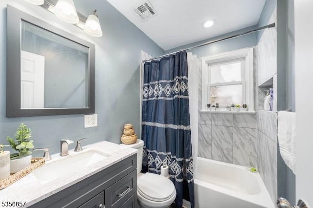 full bathroom featuring toilet, shower / bath combo, and vanity
