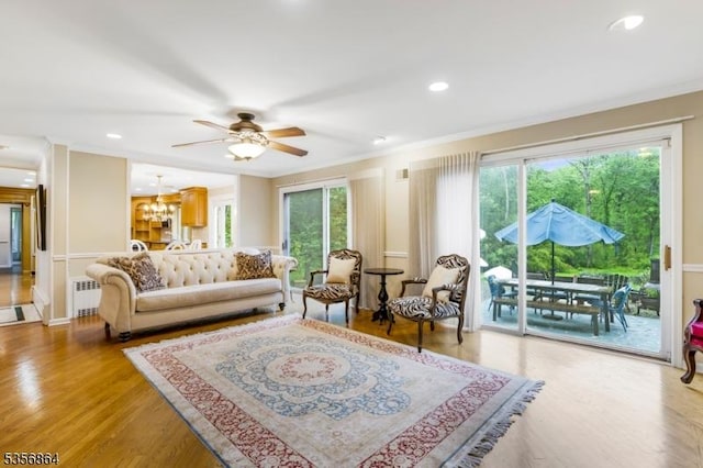 147 Liberty Corner Rd, Bernards Twp, NJ 07920 - living area featuring radiator heating unit, ornamental molding, light wood-type flooring, ceiling fan, and a chandelier